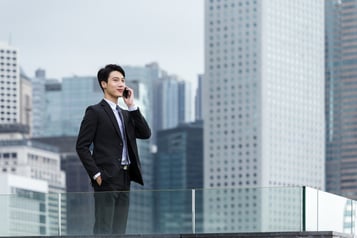 Businessman talk to mobile phone with business background