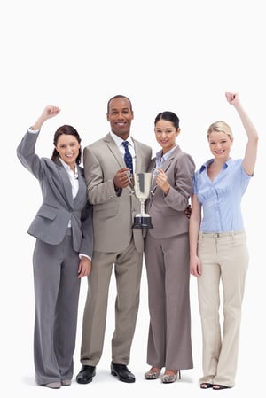 Happy business team holding a cup and raising arms against white background