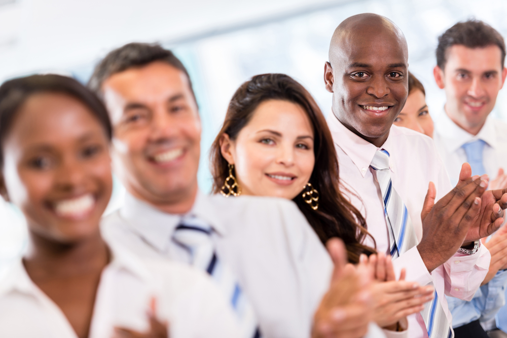 Successful business group applauding after a presentation