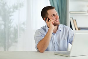 Young businessman with his cellphone in his home office-1