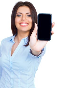 Young woman showing display of mobile cell phone with black screen and smiling on a white background. Focus on hand.