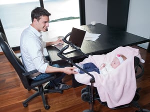 young man parent working on laptop computer at home office and take care of baby